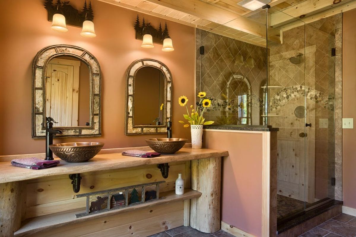 bathroom with coral walls stonework and unique brass sinks