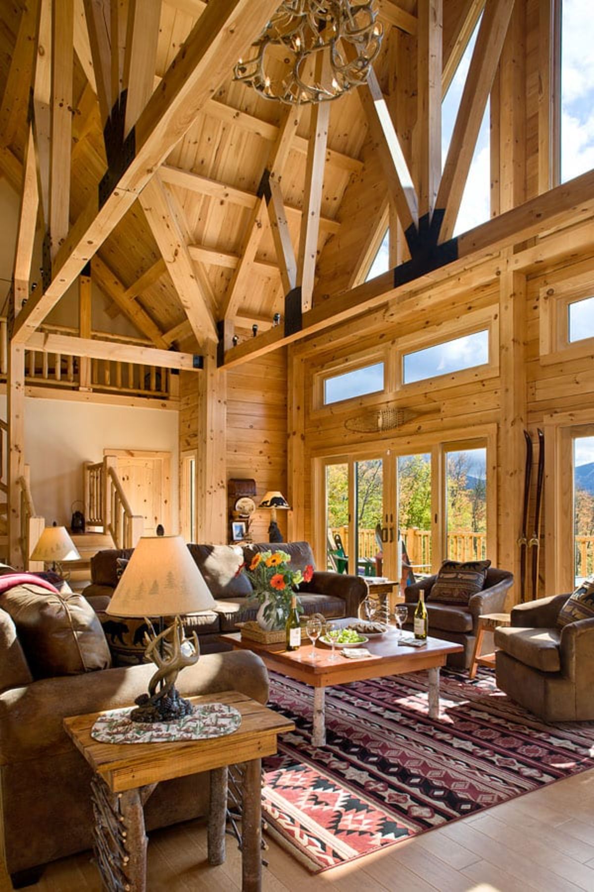 brown sofas in light wood great room with picture window on right wall