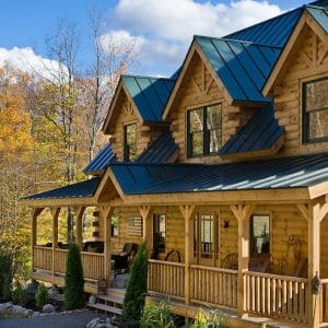 light blonde log cabin with porch and dormer windows on front