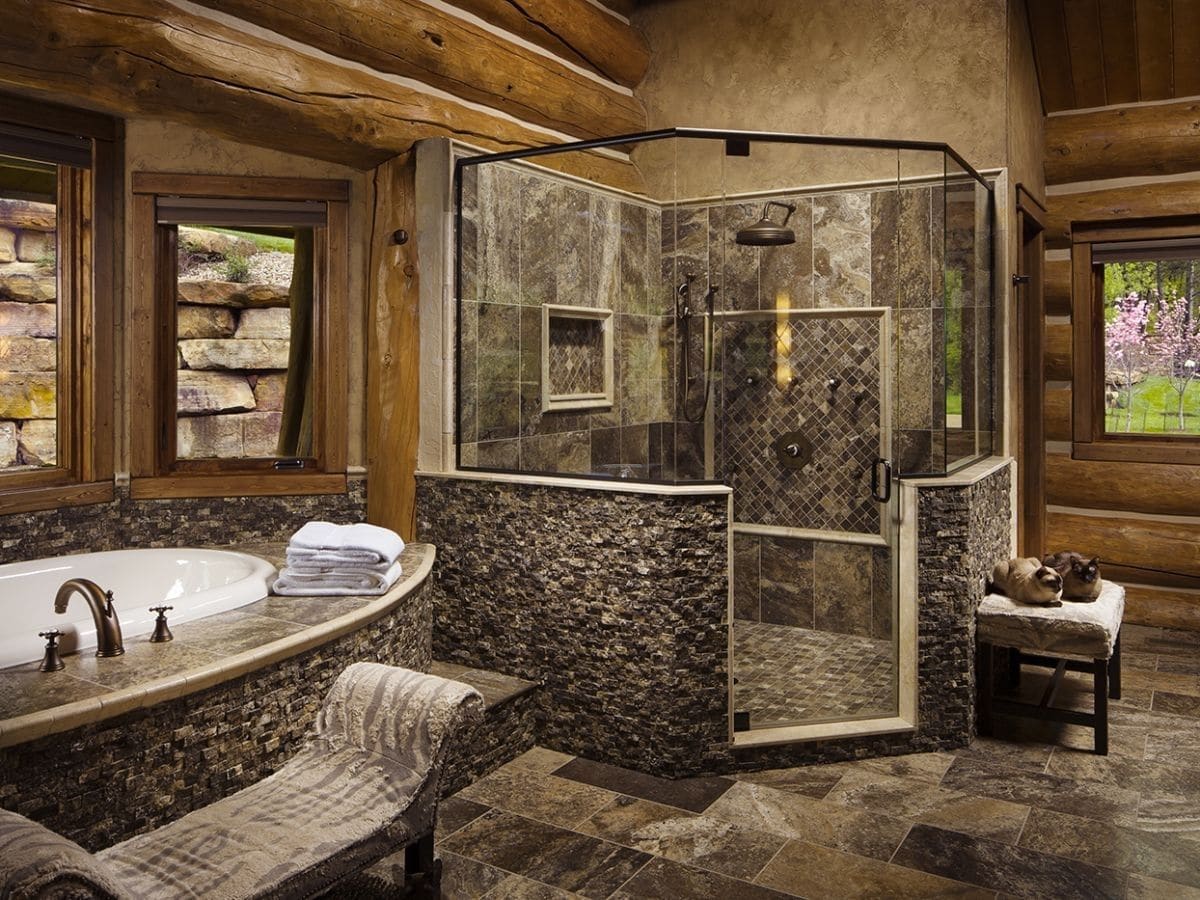 stone lined shower stall at back of bathroom