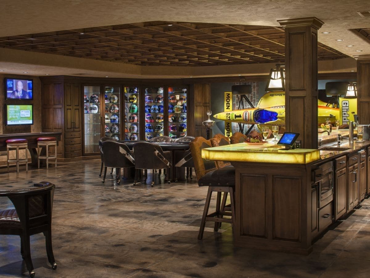 game room bar in foreground with wall of trophies in background