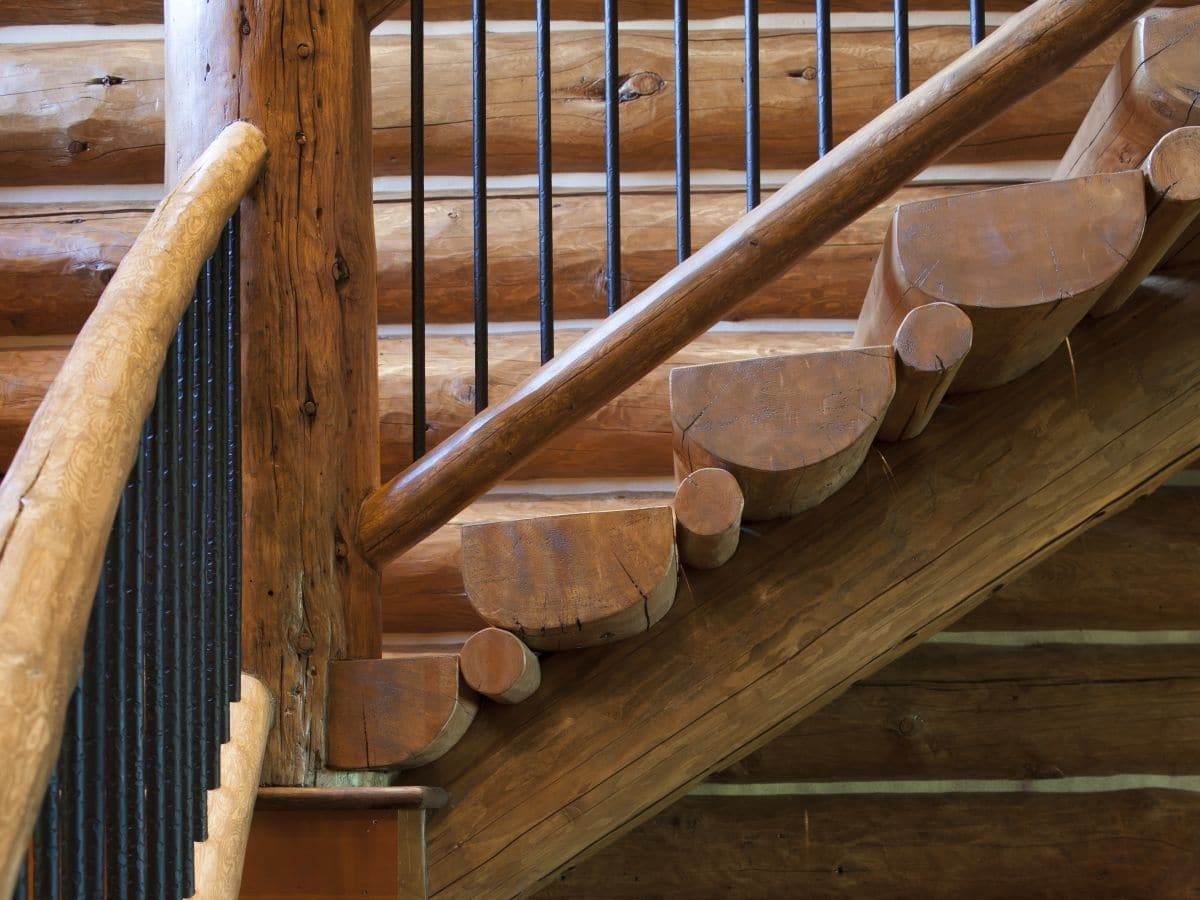 half log steps on stairs leading to second floor of log cabin