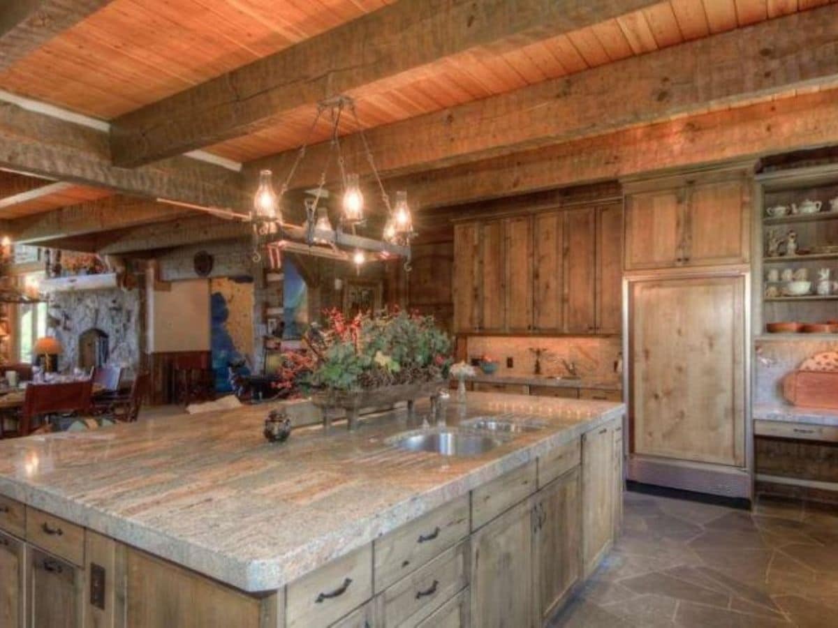 extra wide wood island in kitchen with sink in middle