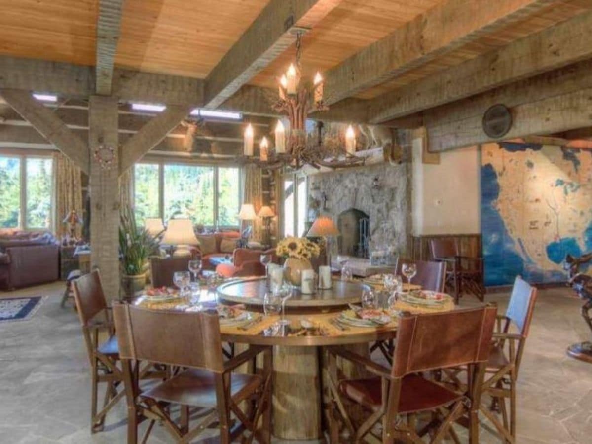 dining table between kitchen and living room with chanelier above