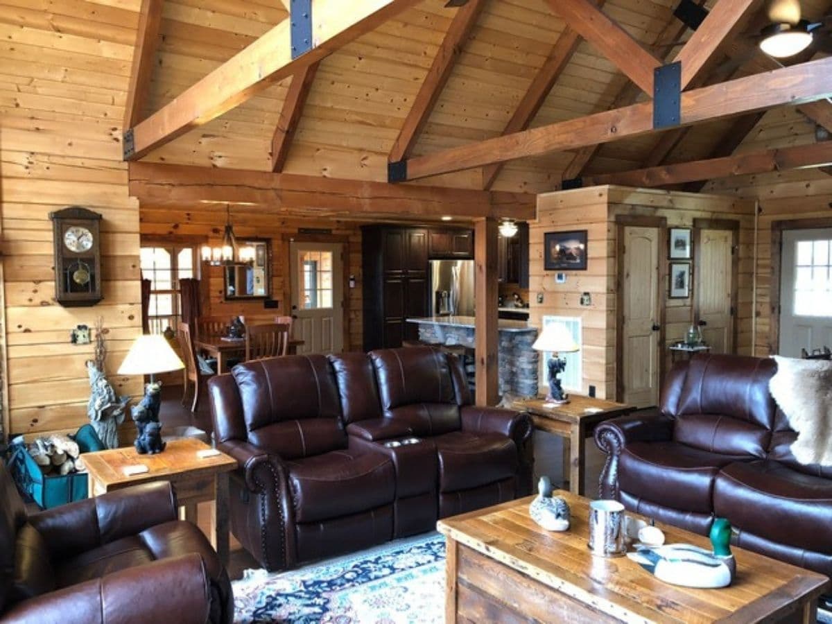 brown leather recliners by wooden coffee table with kitchen in background