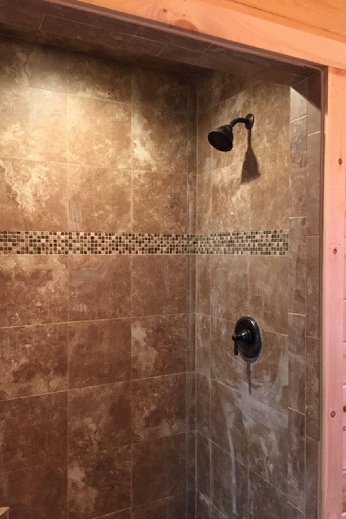 black fixtures in tiled shower
