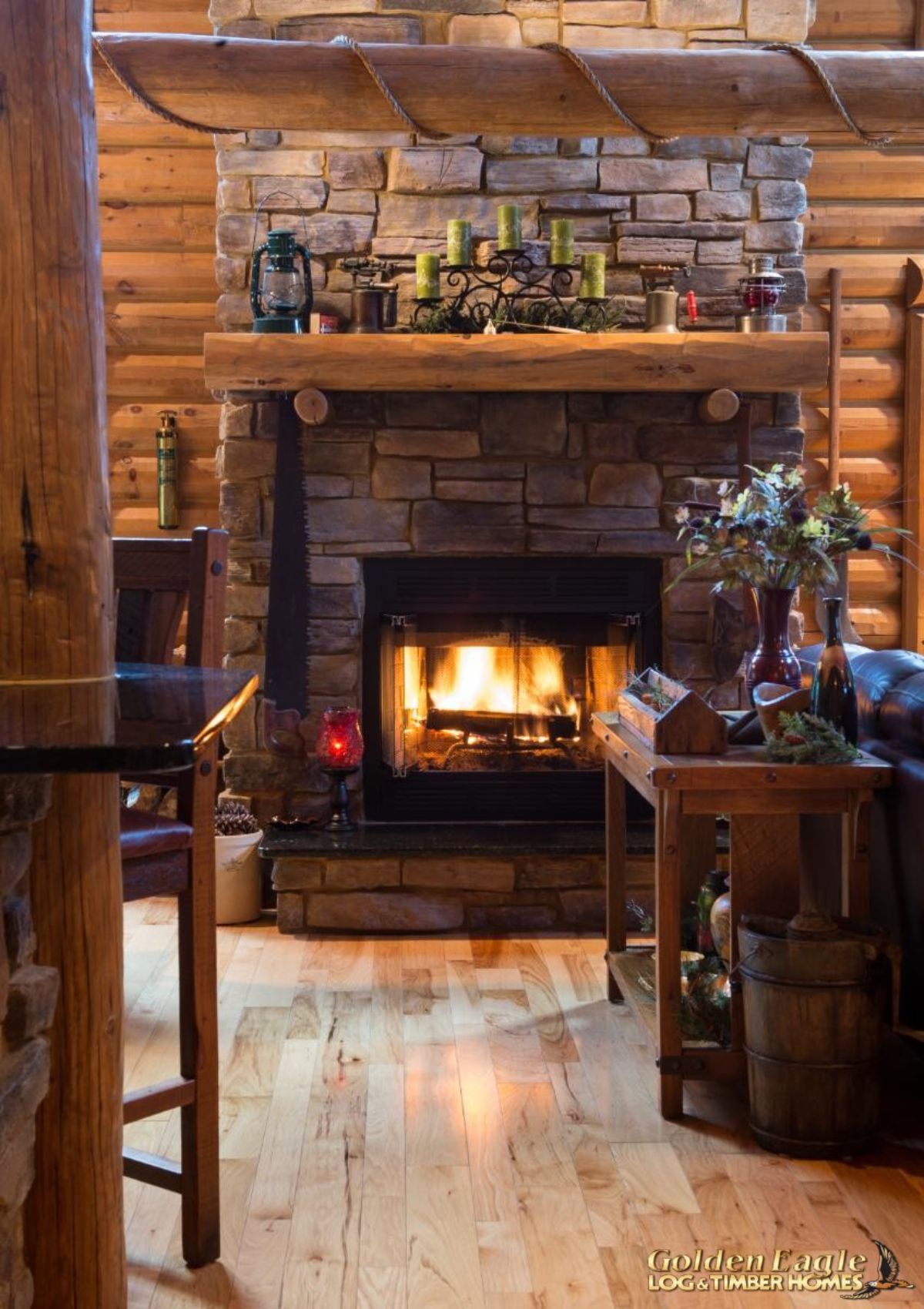 stone fireplace against log cabin walls with log mantle