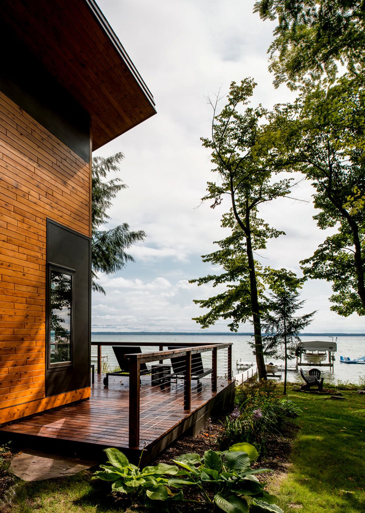 side porch on wood home with lake view