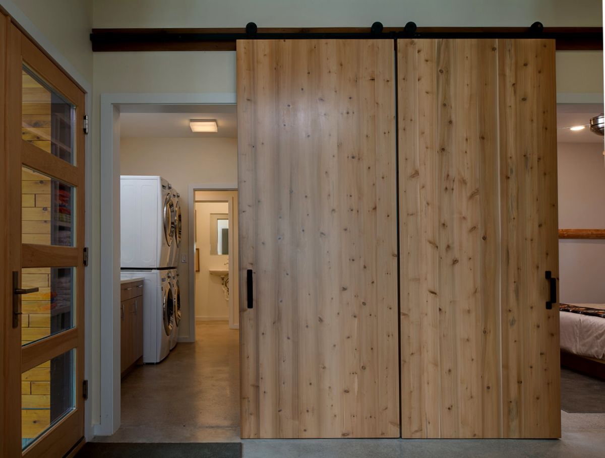 wood doors over entry with barn closure and open spaces on both sides