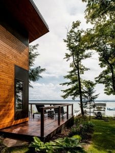 side porch on wood home with lake view