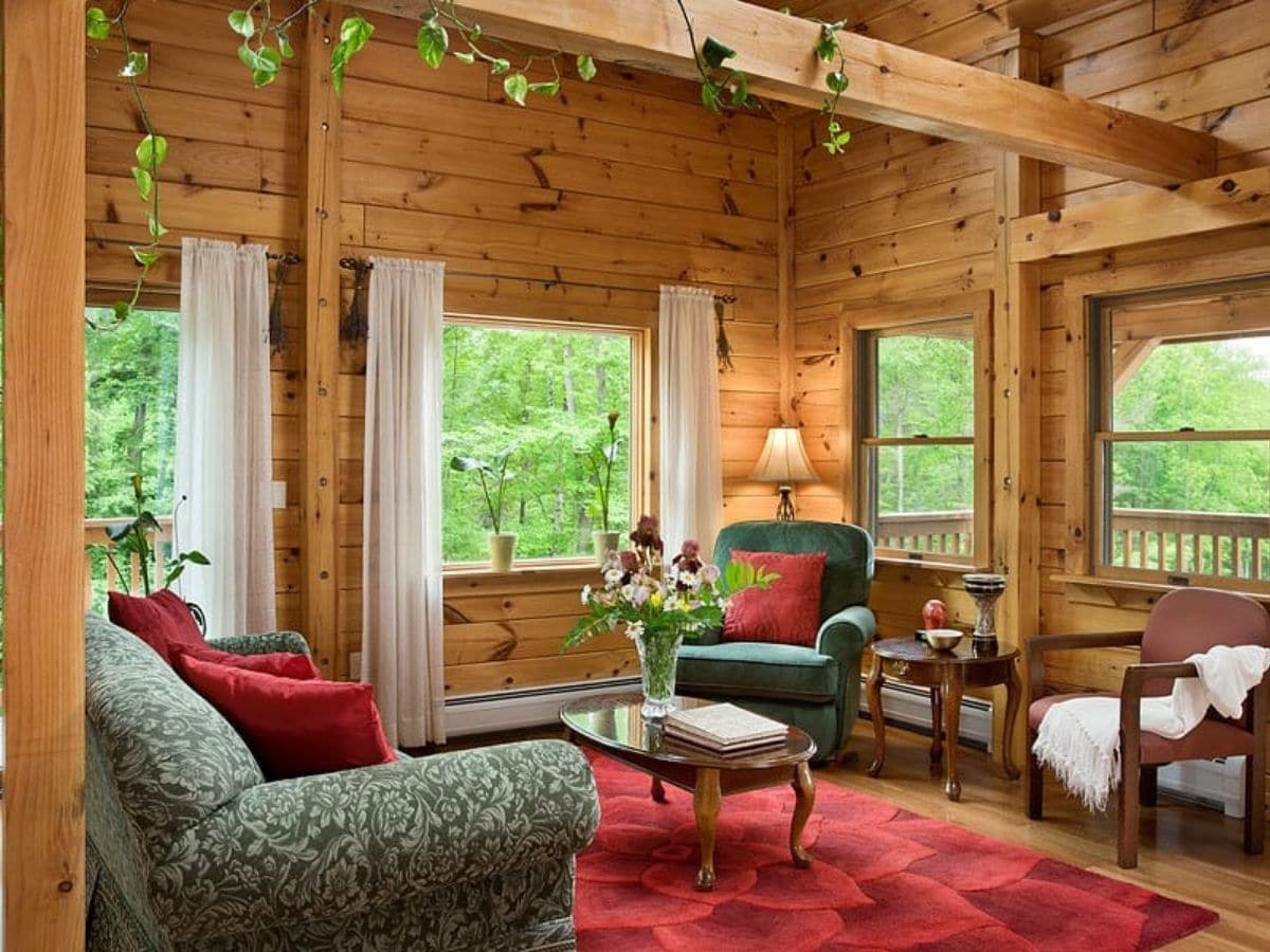 red rug on floor with green chairs on each side