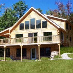 light wood log cabin with walk out basement on grassy hill