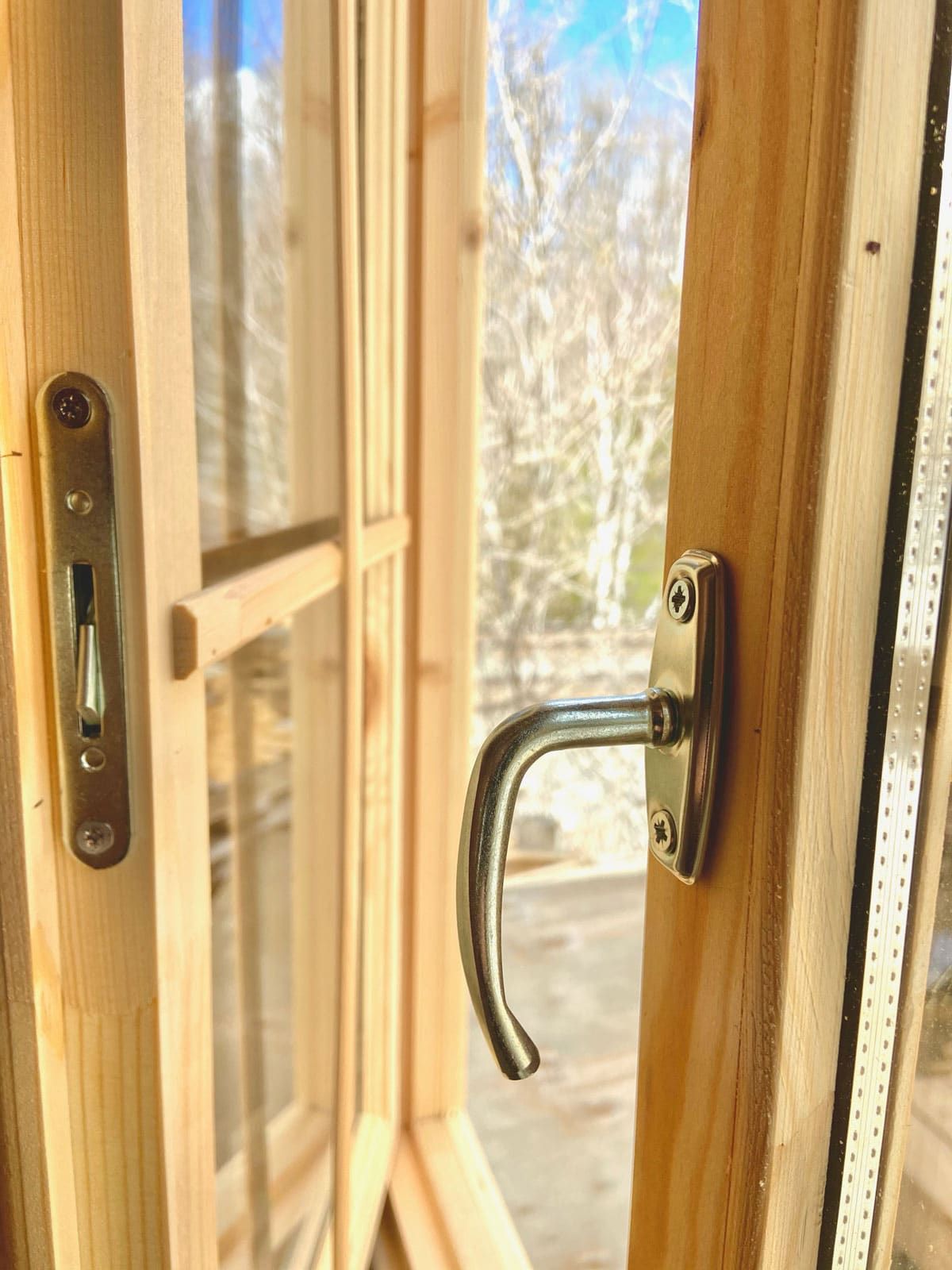 silver handle on window with glass panes