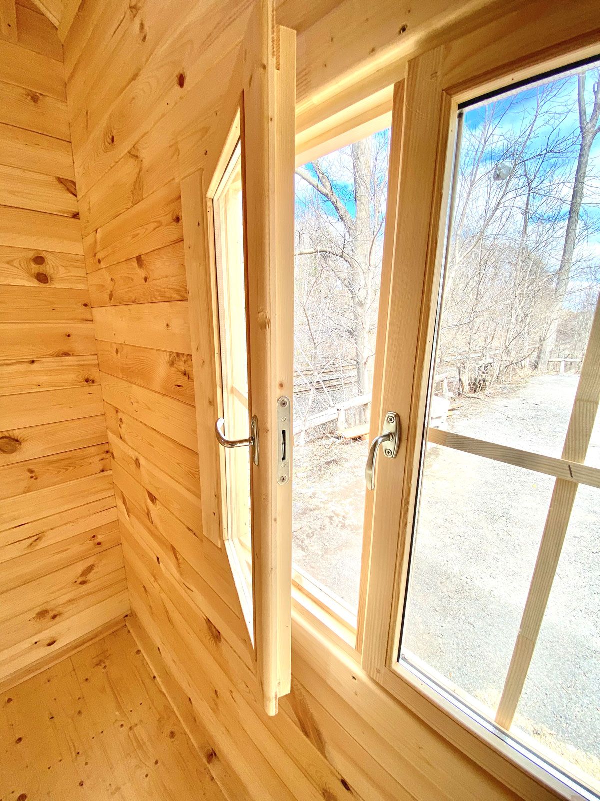 open glass paned window in log cabin