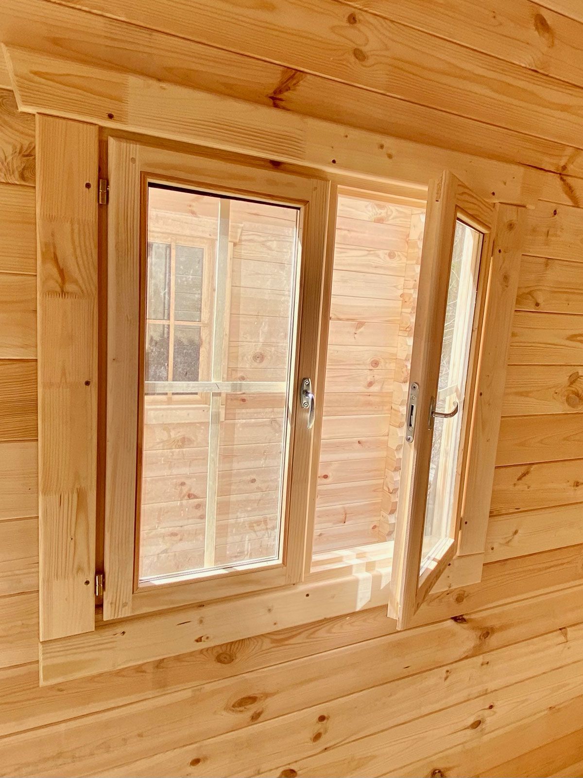 small wood cabin with glass window opening inward