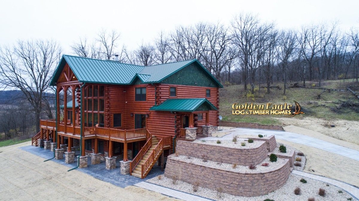 side of log cabin with multiple levels and walk out basement facing left of image