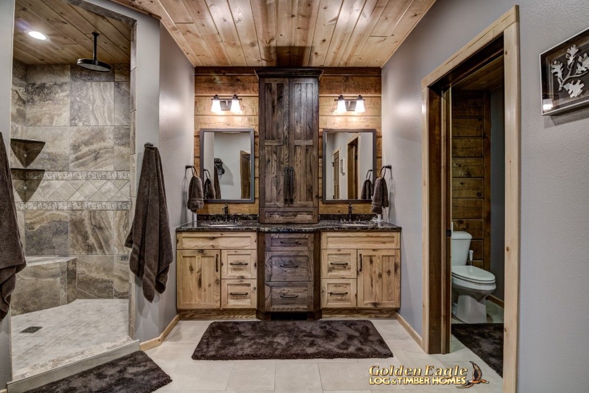 bathroom vanity with light and dark wood beneath mirrors against back wall of bathroom