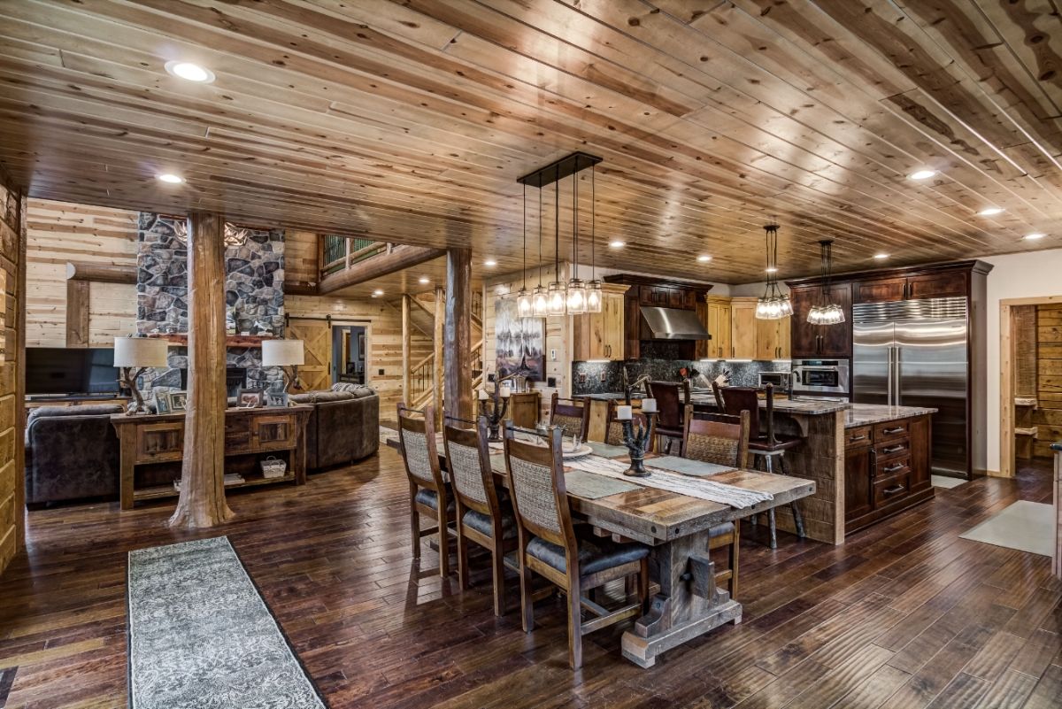 view from behind kitchen table into living space with kitchen in right background