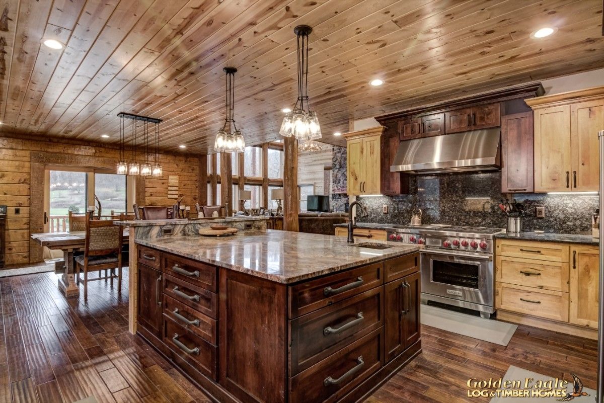 dark wood island in middle of kitchen with silver drawer handles