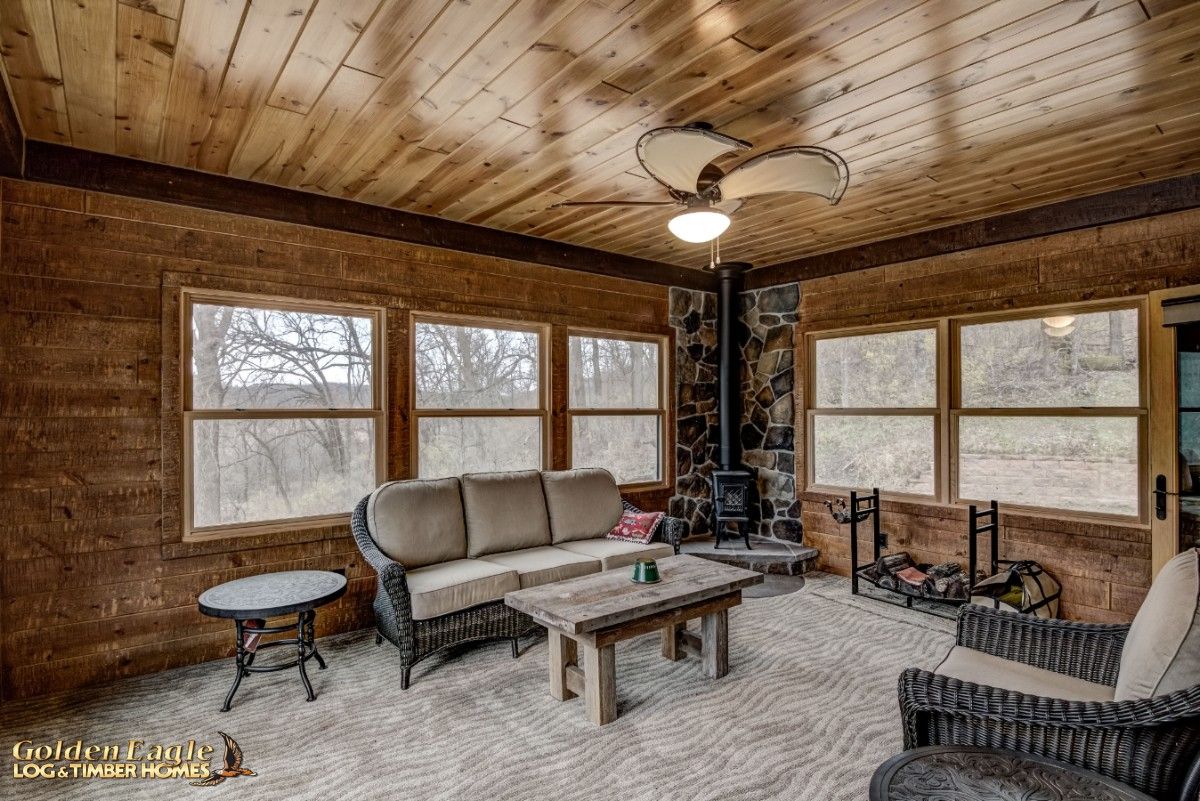 corner wood stove against stone walls with windows on both sides