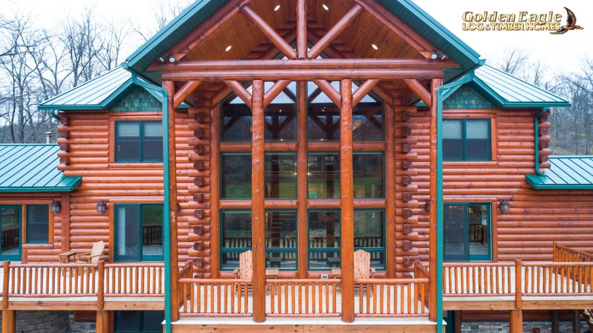 balcony great room windows of log cabin with awning over blacony