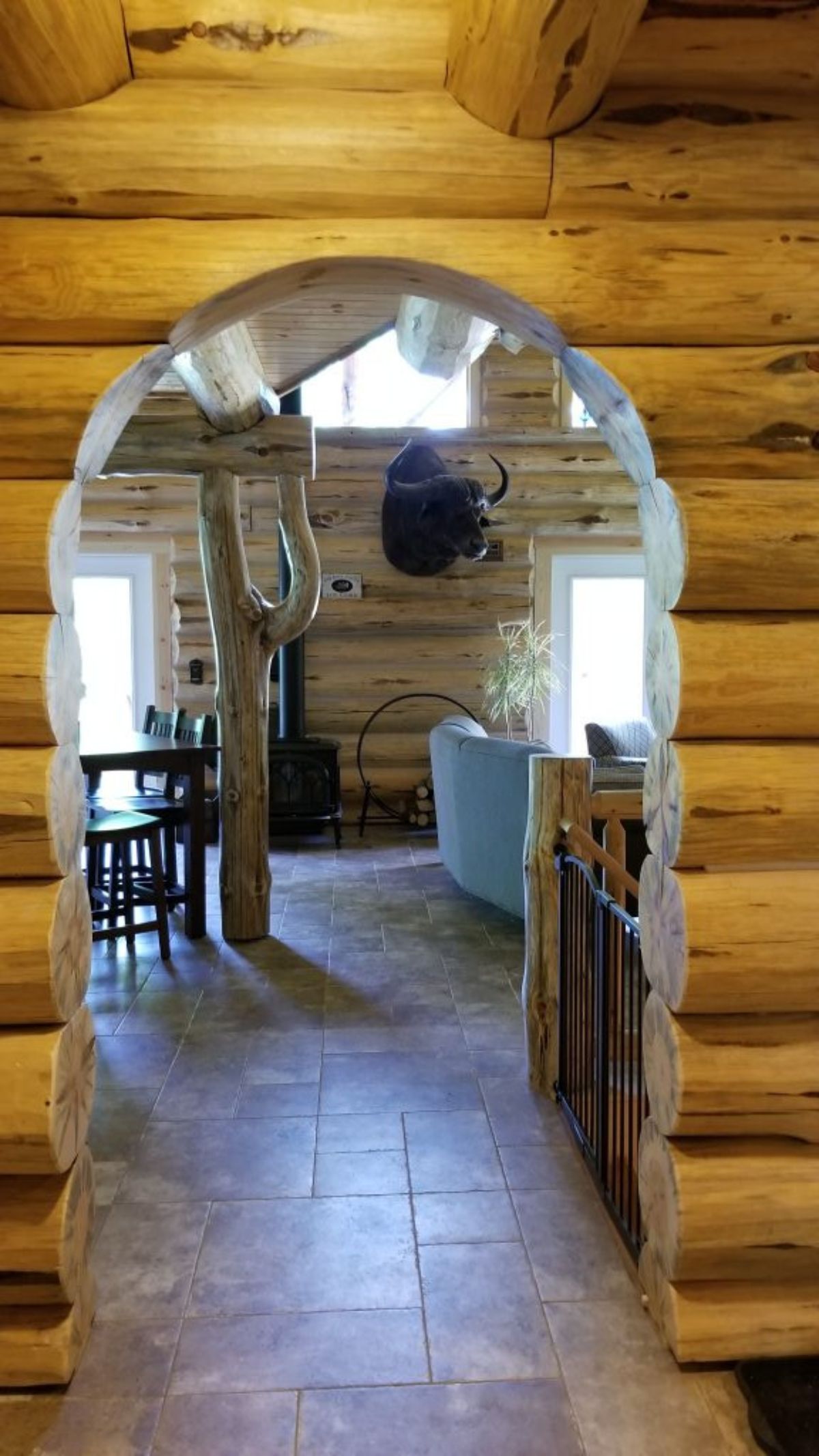 archway leading into living room of log cabin