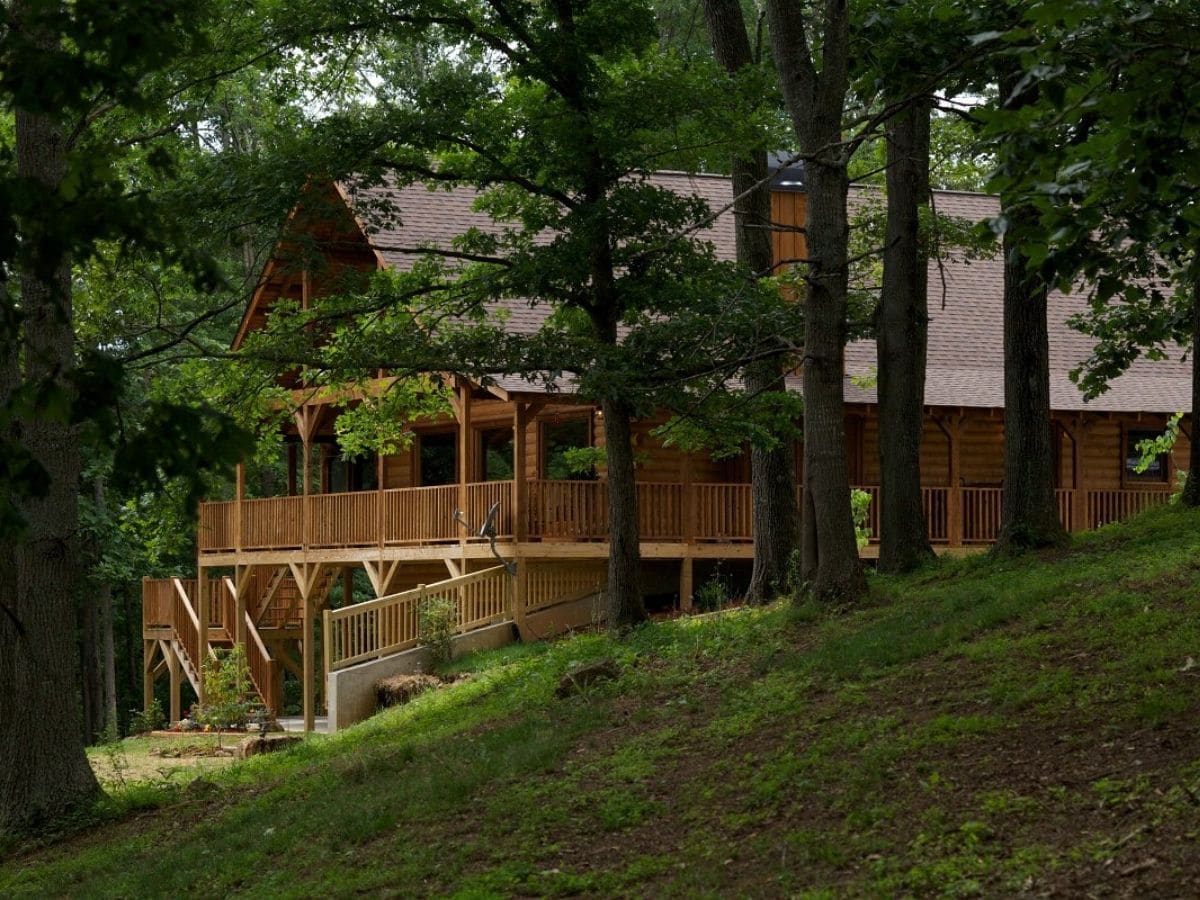 log cabin behind treeline