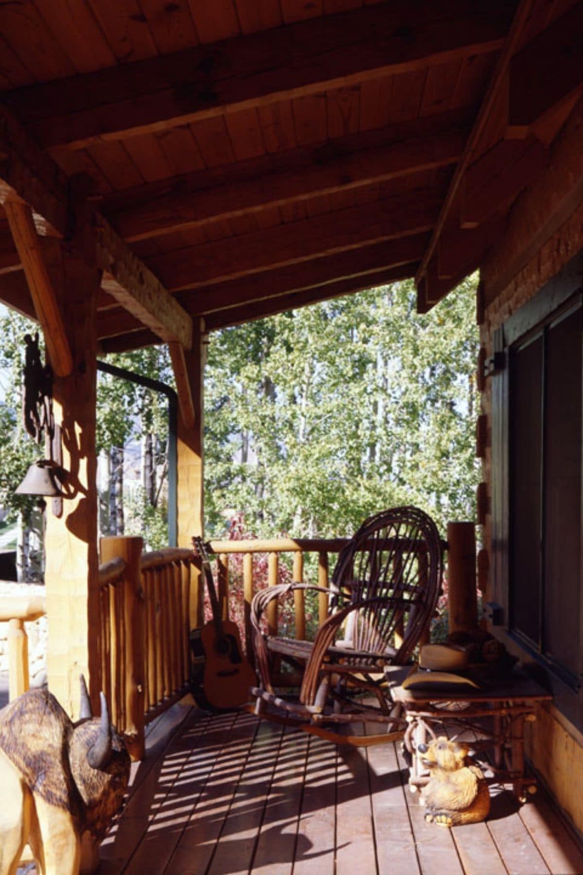 covered front porch with rocking chair by front door