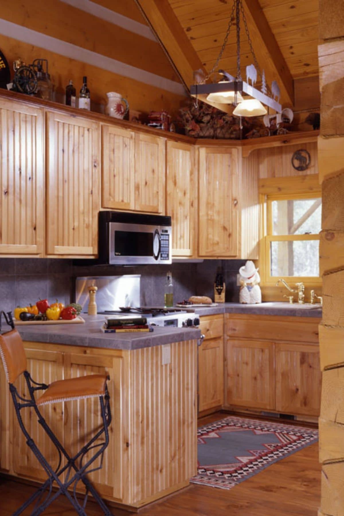 kitchen with wood cabinets and gray countertops and stainless steel microwave