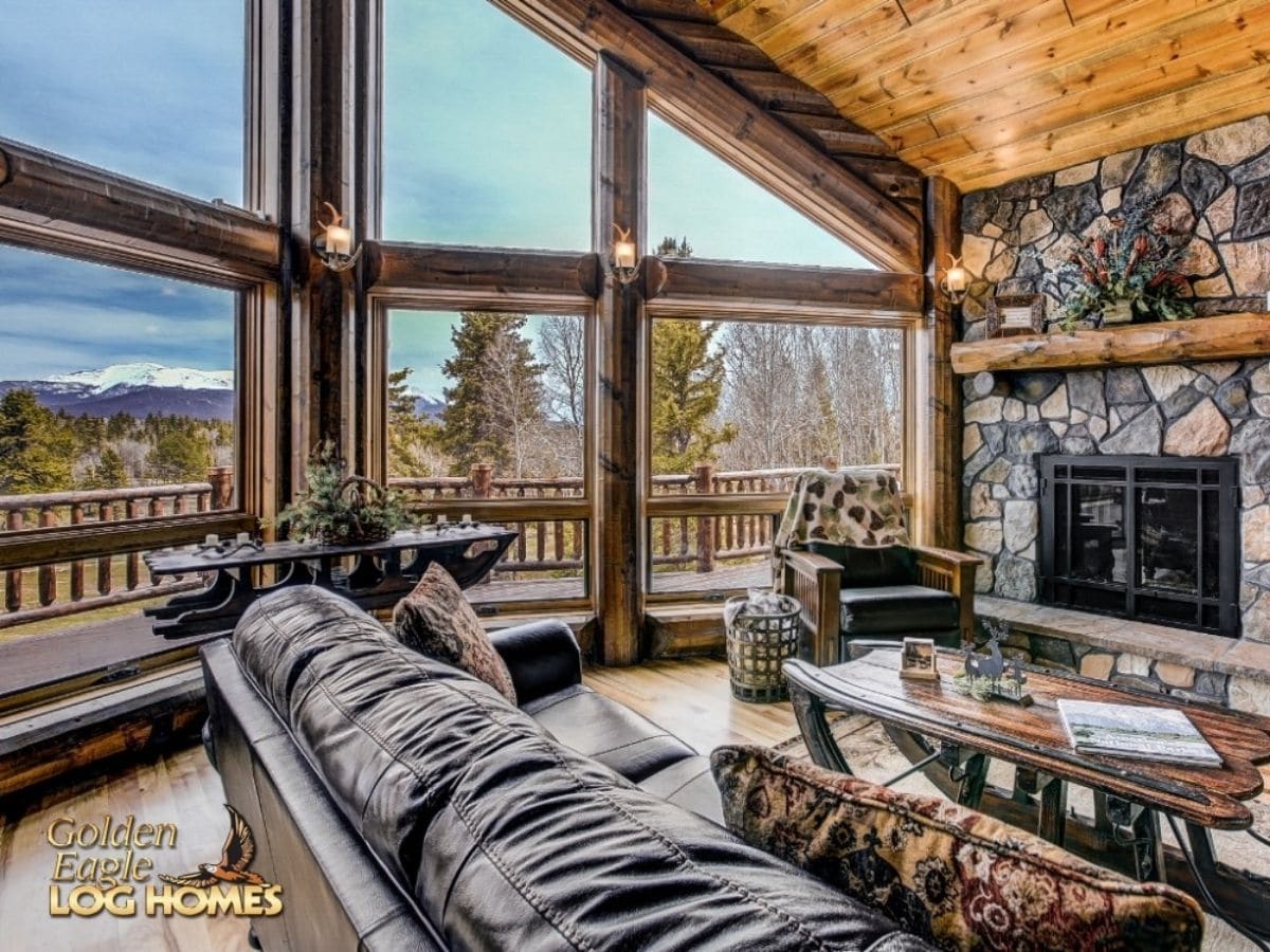 leather sofa in foreground with great room windows on side wall