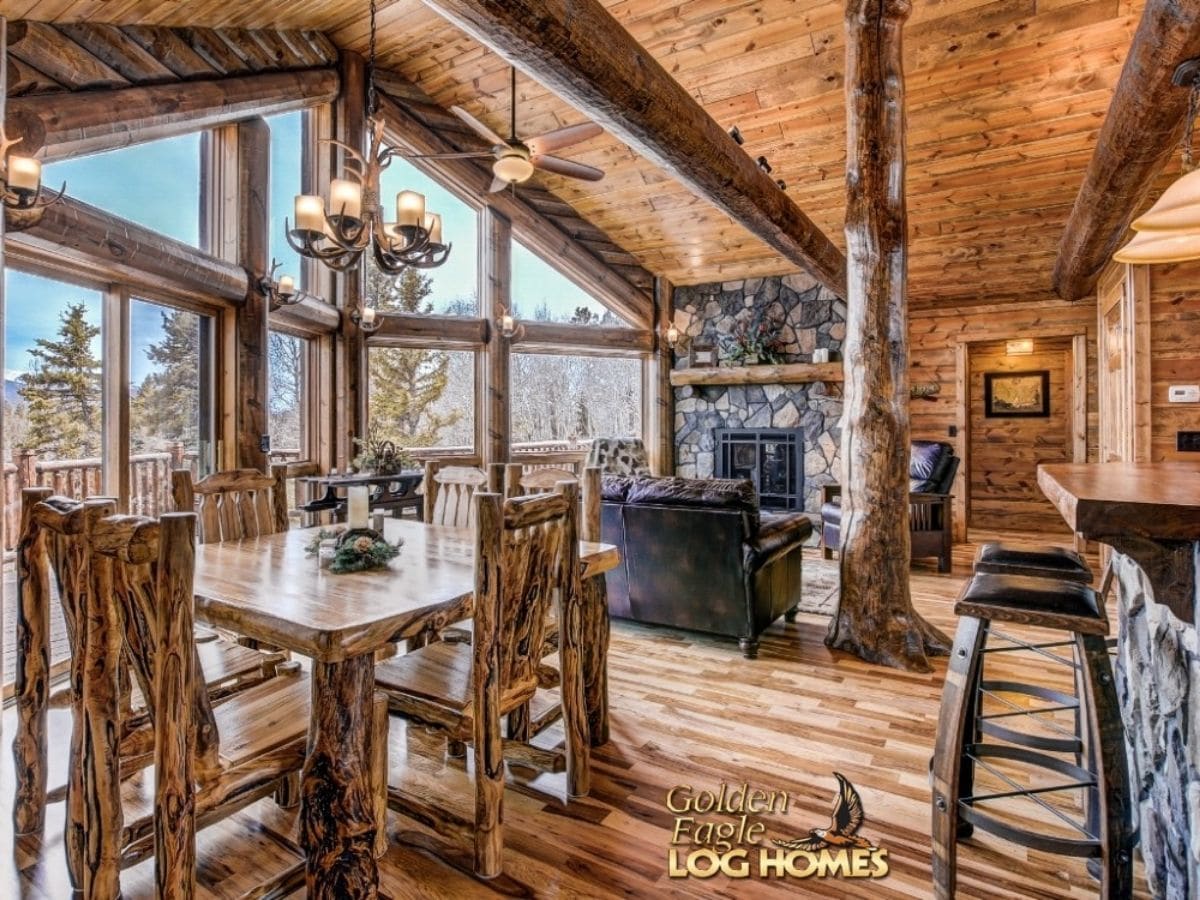 view from kitchen into living room with stone fireplace against wall