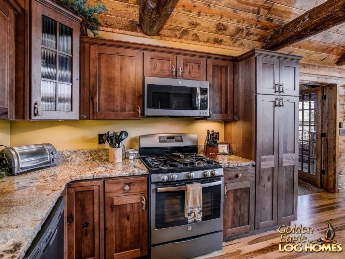 stainless steel stove in dark wood cabinets