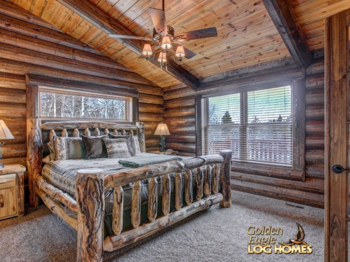 log bed frame in large log cabin kitchen