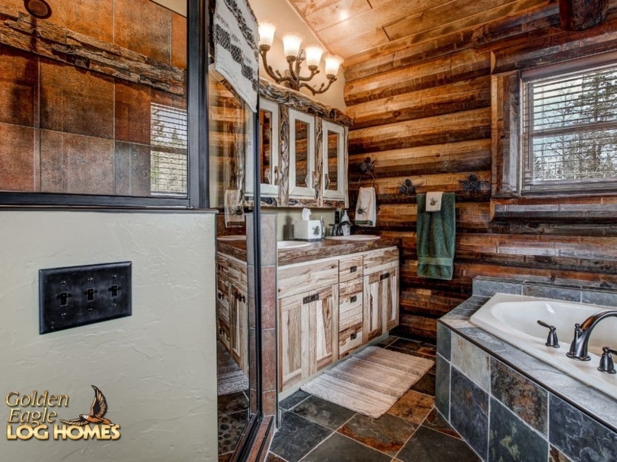 master bathroom with tile floor against log walls