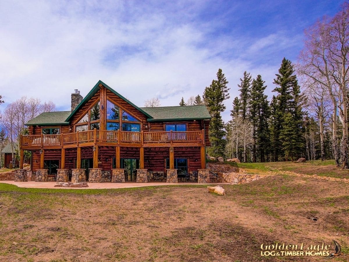 log cabin with stone base on columns for walkout basement