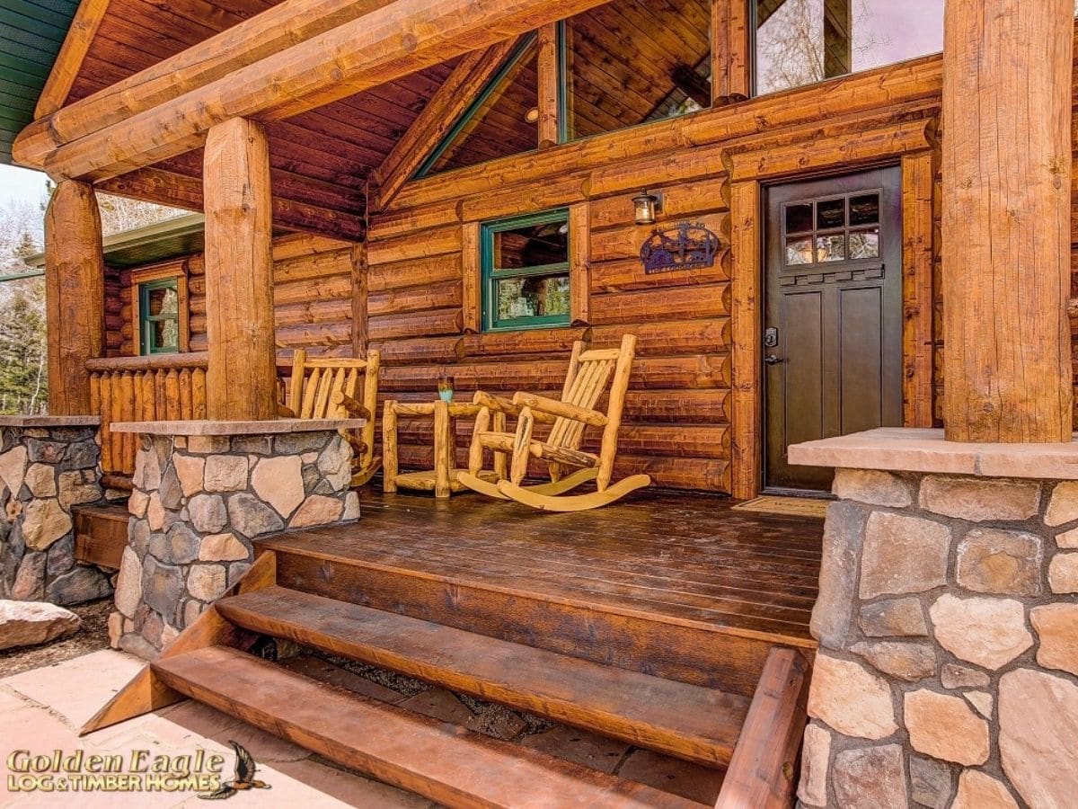 rocking chair on porch with stone columns