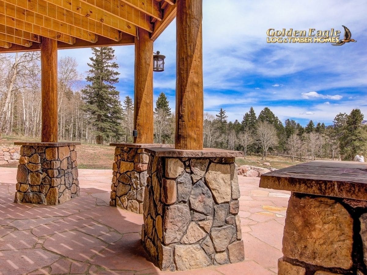 stone base on columns under deck of log cabin