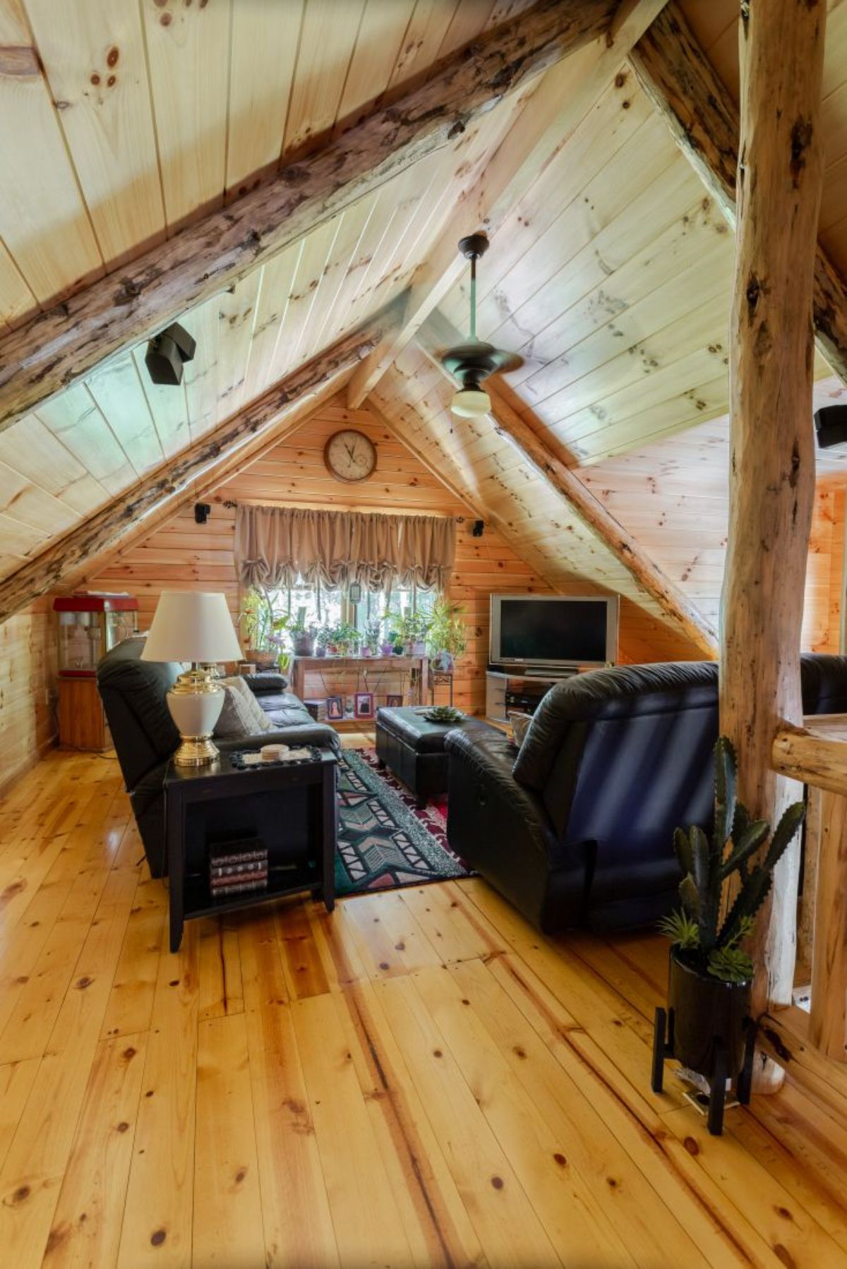 black chairs under arch of log cabin attic