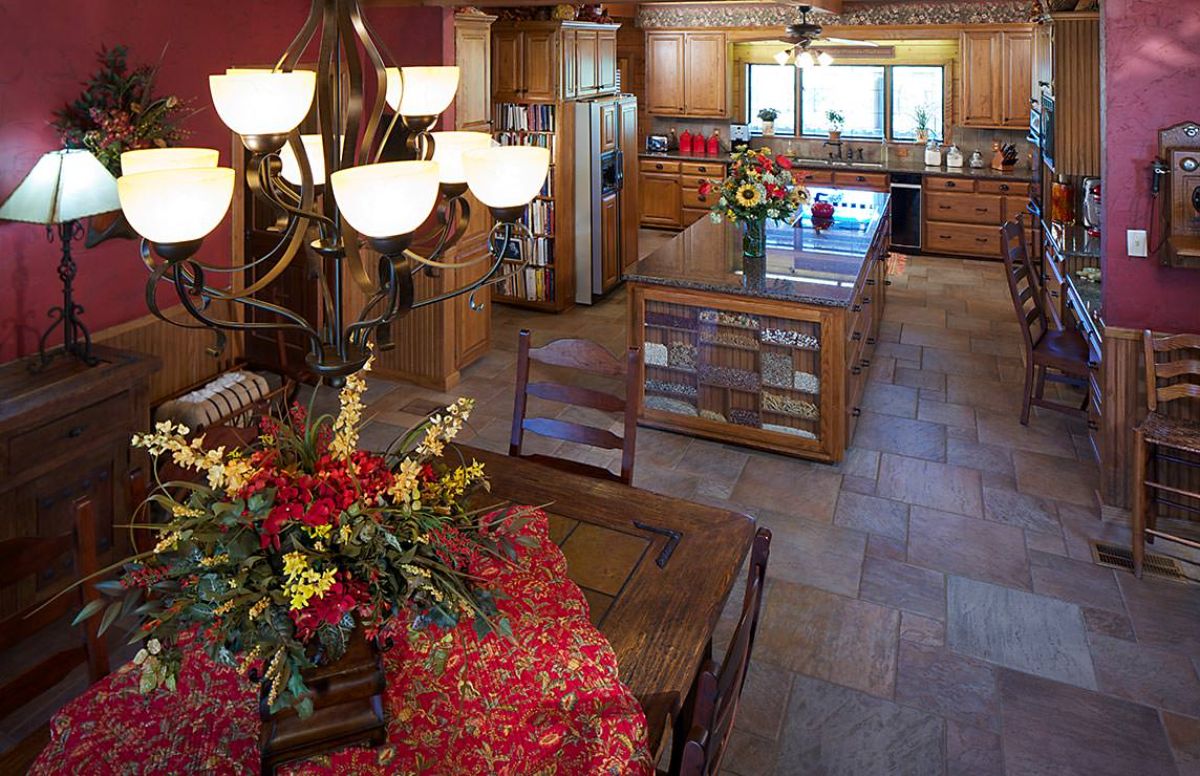 log cabin kitchen with dark wood island and stainless steel appliances