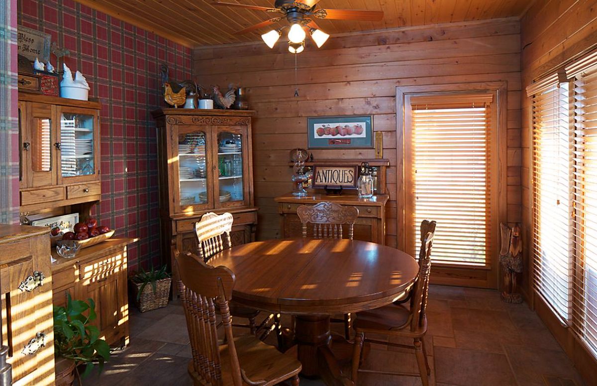 round dining table with hutch in corner of room