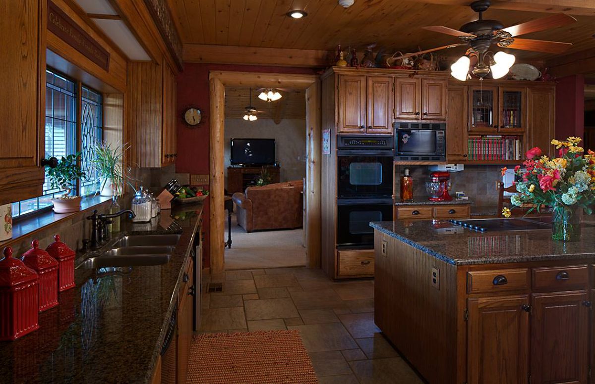 view from kitchen into living room with oven by door