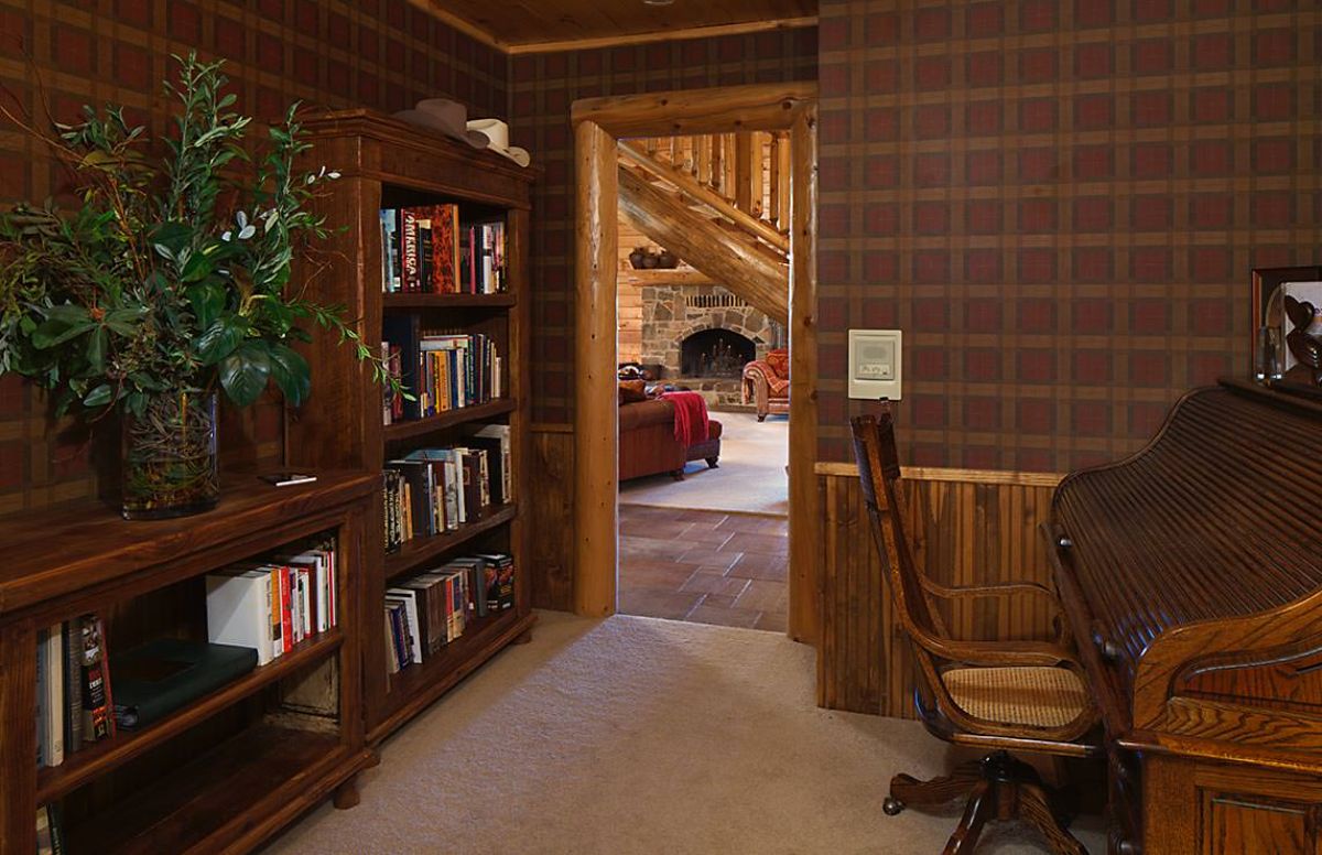 library office off living room with patterned wallpaper