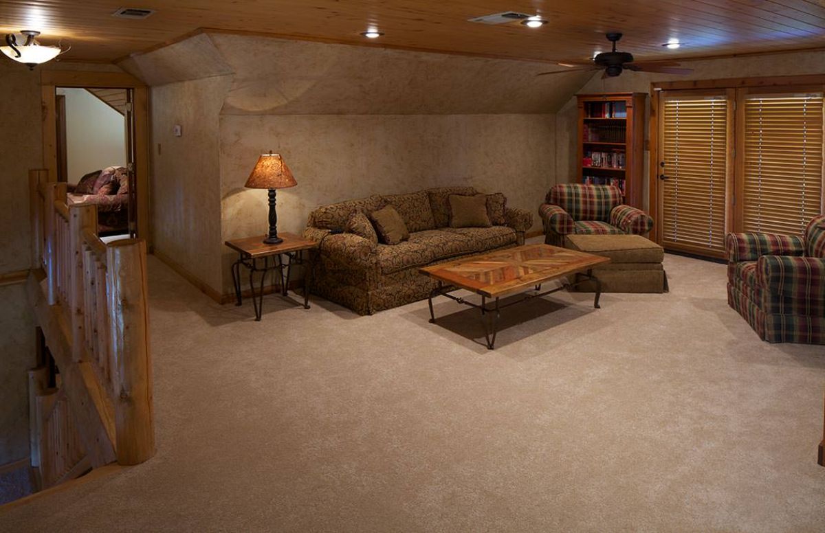 sofa against wall in basement with wood coffee table in front