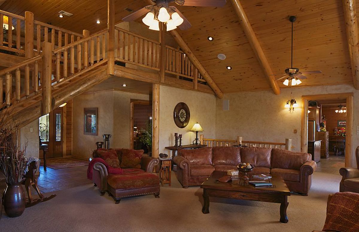 red leather sofas with wood coffee table in living room of log cabin