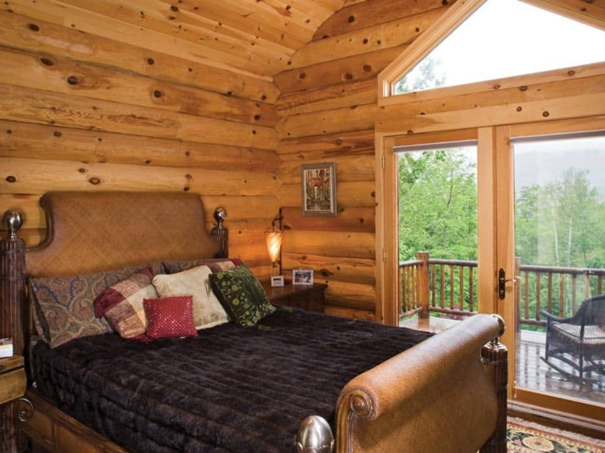 black blanket on sleigh bed net to open doors to balcony