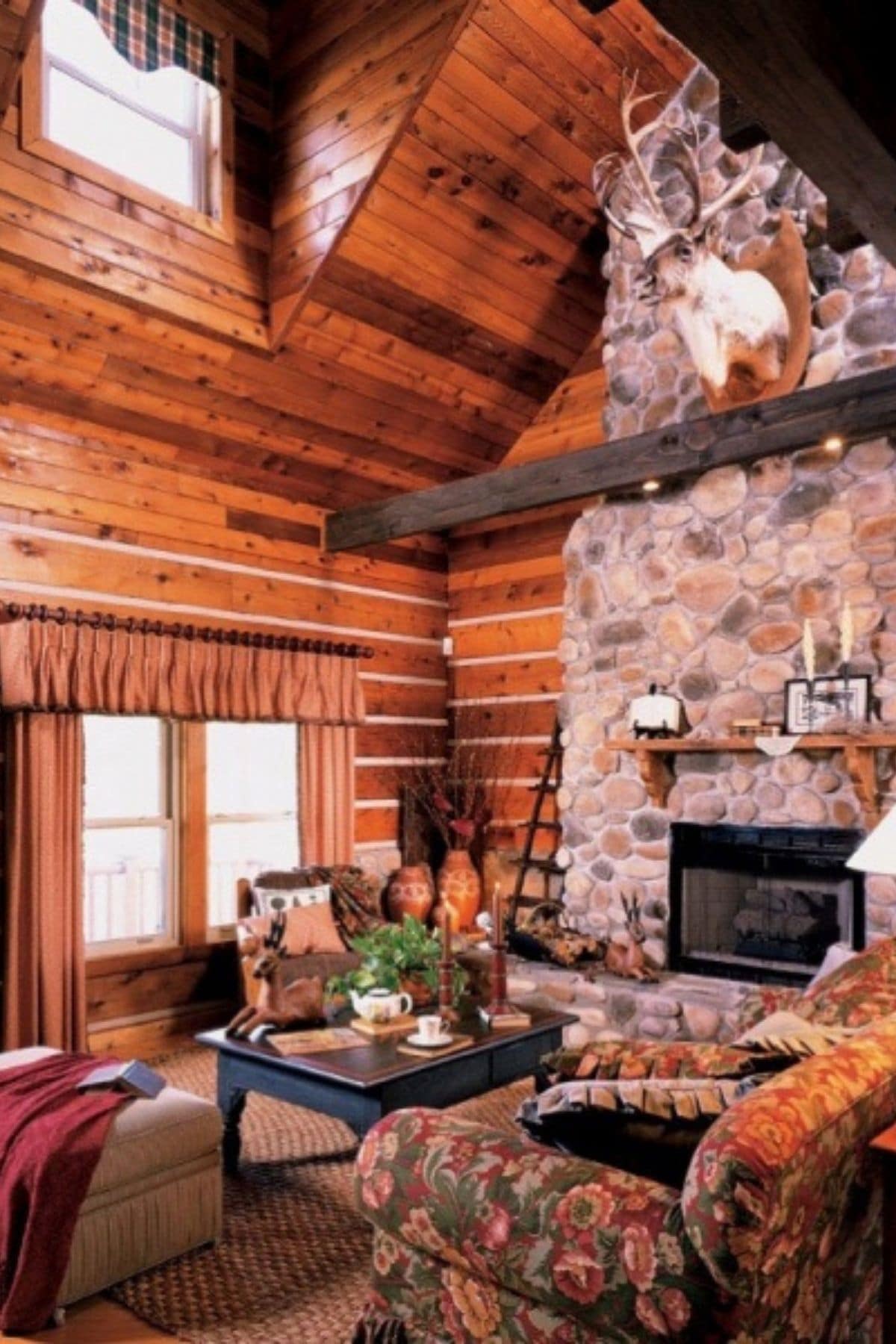 stone fireplace agaisnt log cabin wall with log mantle