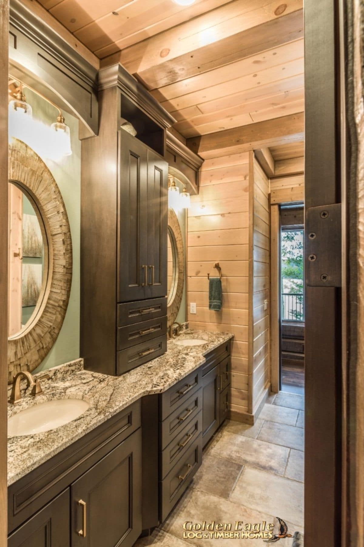 marble counters in bathroom with dark wood cabinets and light walls