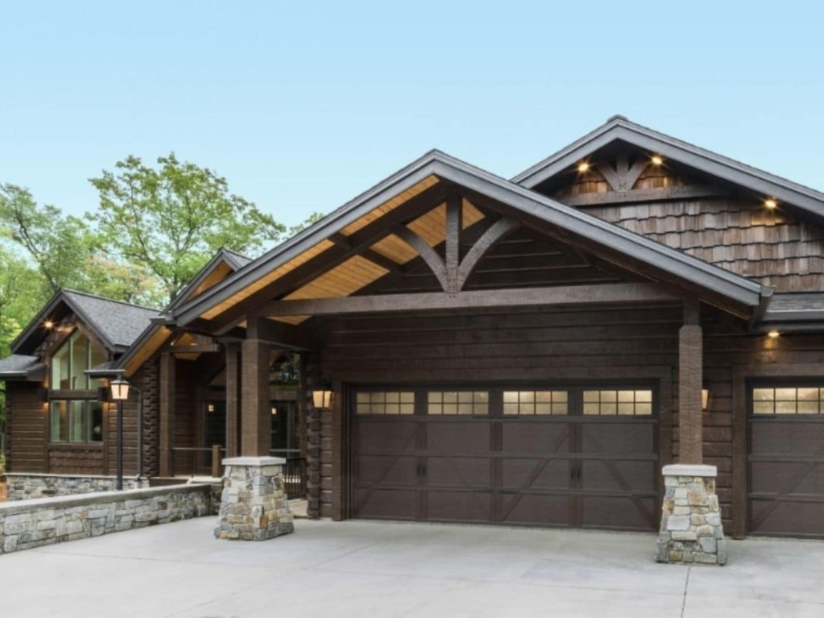 brown garage door on front of log cabin