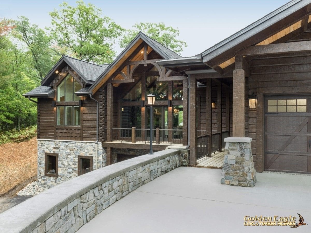 driveway and walkway of log cabin with stone rail