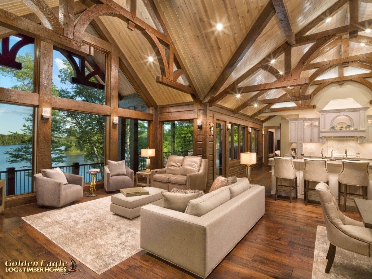 white sofa in great room with dark wood log beams above